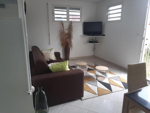a living room with a couch and a tv at BELLA in Gros-Morne