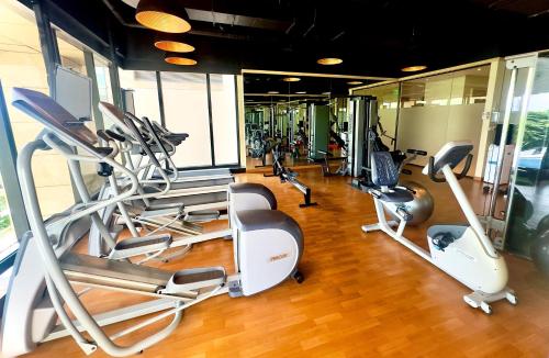 a gym with several treadmills and elliptical machines at Holiday Inn Bengaluru Racecourse by IHG in Bangalore