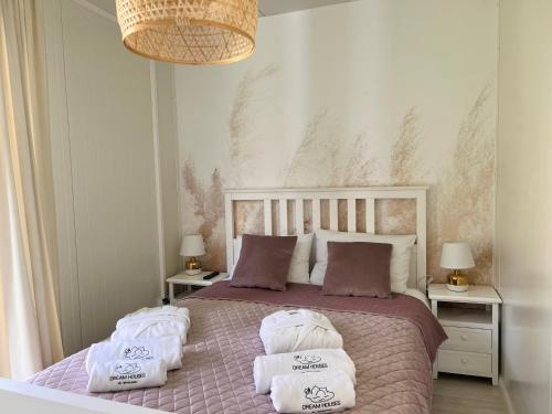 a bedroom with a bed with two towels on it at Ironland Roztocze in Ruda Żelazna