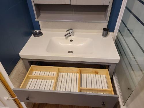 a bathroom with a sink in a cabinet at Grand appartement au pied des pistes ! in Chamrousse