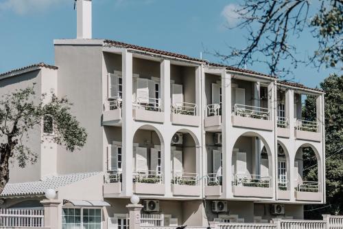 a white building with balconies on it at Pelithea Aparthotel in Corfu