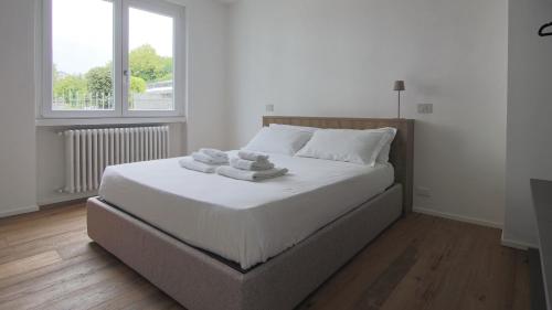 a bedroom with a bed with towels on it at Hotel Corte Santa Libera in San Fedele Intelvi