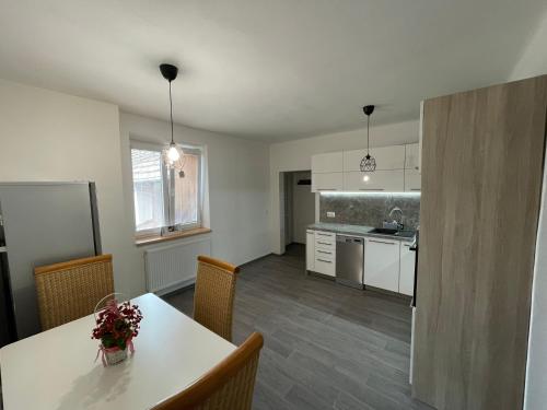 an empty kitchen with a table and chairs in a room at Apartmán SUŠICE in Sušice