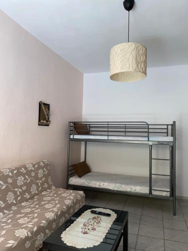 a living room with a couch and a bunk bed at Villa Vasiliki in Metamorfosi