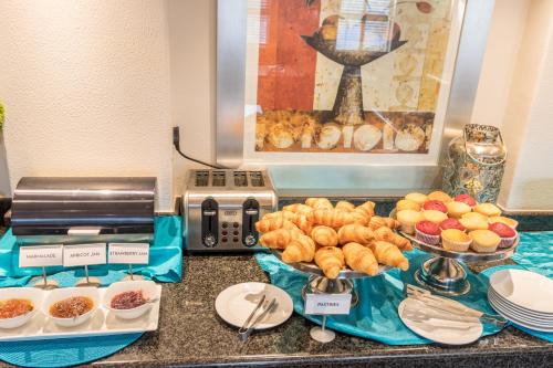 a buffet with bread and other food on a counter at Road Lodge Isando in Germiston