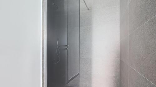 a shower with a glass door in a bathroom at Hotel Corte Santa Libera in San Fedele Intelvi