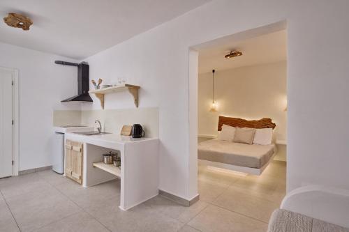 a bathroom with a sink and a bed in a room at Casa Philippi Suites in Mikonos