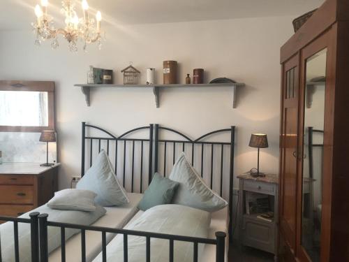 a bedroom with a bed with pillows on it at Ferienhaus Schillerstraße in Münsingen