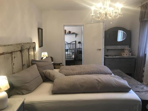 a bedroom with a bed and a chandelier at Ferienhaus Schillerstraße in Münsingen