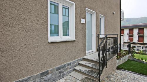 a building with a staircase next to a window at Hotel Corte Santa Libera in San Fedele Intelvi