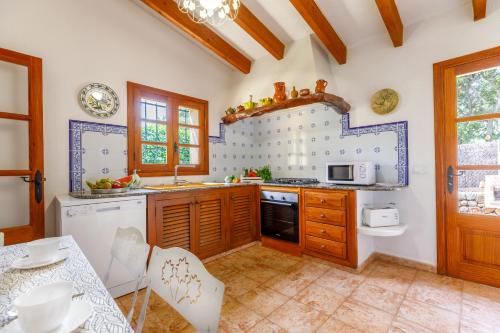 uma cozinha com um lavatório e um fogão forno superior em Navarro em Pollença