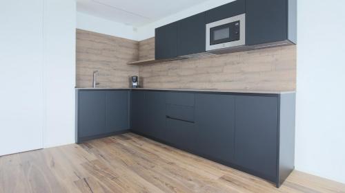 a kitchen with a counter and a tv on a wall at Hotel Corte Santa Libera in San Fedele Intelvi