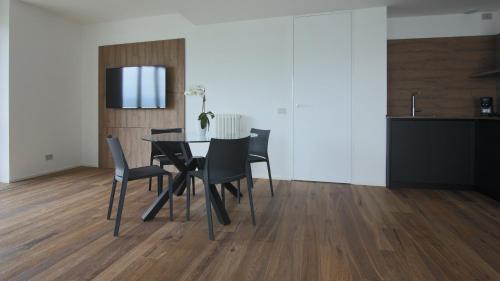 a dining room with a black table and chairs at Hotel Corte Santa Libera in San Fedele Intelvi