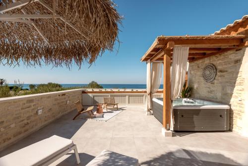 a patio with a view of the ocean at Pileas Villa, a Supreme Retreat by the Βeach, By ThinkVilla in Pigianos Kampos