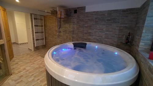 a large blue bath tub in a bathroom at Vila Stecker - Zámeček pod Špičákem in Tanvald