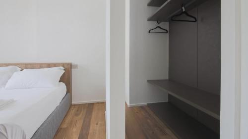 a bedroom with a bed and a black cabinet at Hotel Corte Santa Libera in San Fedele Intelvi
