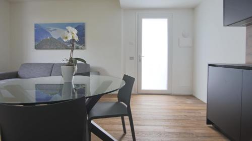 a dining table and chairs in a living room at Hotel Corte Santa Libera in San Fedele Intelvi