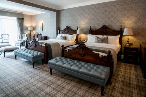 a large bedroom with two beds and a couch at Harvey's Point in Donegal