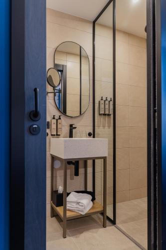a bathroom with a sink and a mirror at Hotel St Joris I Kloeg Collection in Middelburg