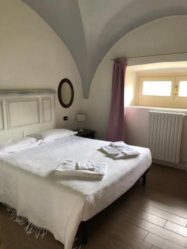 a bedroom with a bed with two towels on it at Antica Casa Fenaroli in Iseo
