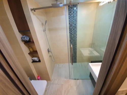 a bathroom with a shower and a toilet and a sink at Hi Sea E272 At Escape Condominium Mae Pim Beach in Mae Pim