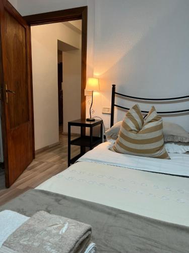 a bedroom with a bed with a pillow and a lamp at Casa de' Trinci in Foligno