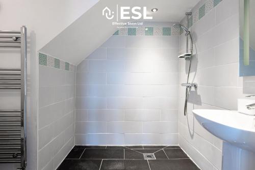 a bathroom with a sink and a shower at Modern, Sea Themed Ground Floor Flat Near Beach in New Quay