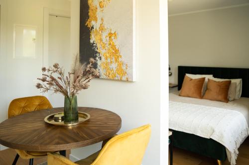 a room with a table and a bed and a bedroom at Apartment in Kesterciems in Ķesterciems