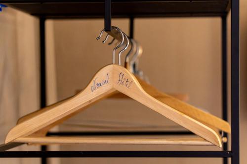 a couple of wooden hangers on a rack in a microwave at Nouvel Hôtel in Paris