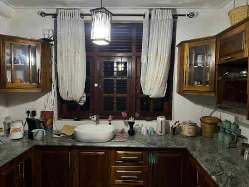 a kitchen counter with a sink and a window at Rustic Mahaweli in Kandy