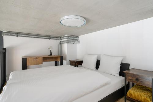 a bedroom with a white bed and a blue light at RentPlanet - Apartamenty Zarembowicza in Wrocław