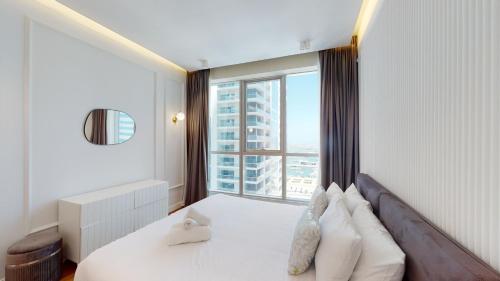 a hotel room with a bed and a large window at Key View - Torch Tower in Dubai