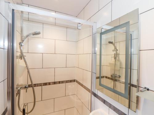 a bathroom with a shower with a glass door at Charlotte's House in Penzance