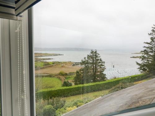 a view of the ocean from a window at Whispering Pines in Bantry