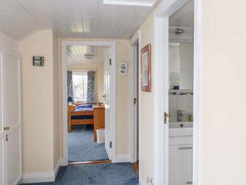 a hallway with a room with a bathroom and a bedroom at Whispering Pines in Bantry