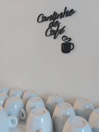 a bunch of white cups sitting in a row at Pousada do Pórtico in Gramado