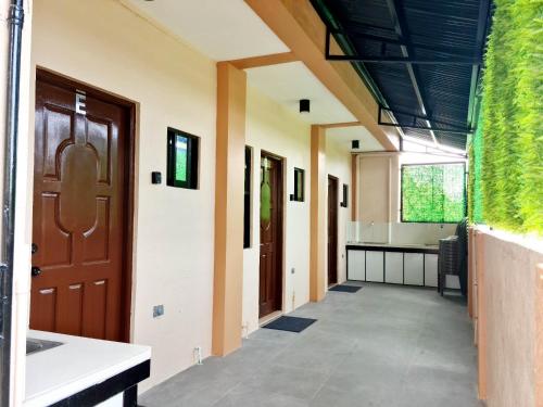 an empty hallway with a door and a kitchen at Cozy BNB - Unit G in Batangas City