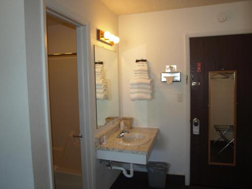 a bathroom with a sink and a mirror at Yellowstone River Inn in Glendive