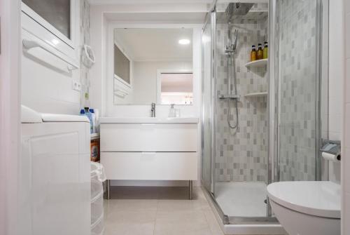 a bathroom with a shower and a sink and a toilet at El Acuario - Primera línea y todas las ventanas dan al mar in Cullera