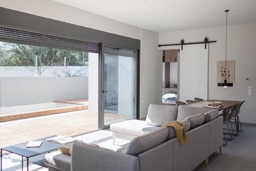 a living room with a couch and a table at NIMA Suites in Paleros