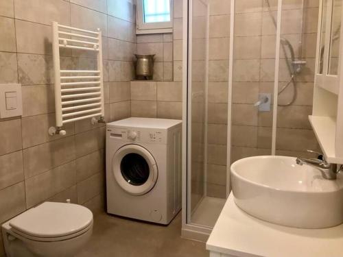 a bathroom with a washing machine and a sink at Da Raffaele in Fondi