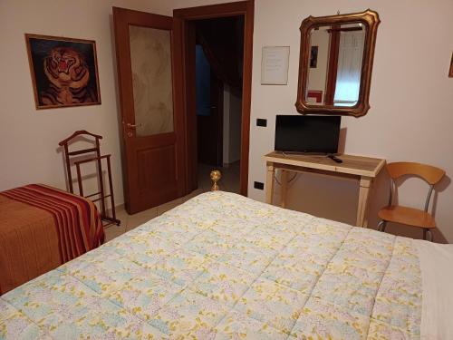 a bedroom with a bed and a desk with a computer at B&B Lattemiele in Fontanellato