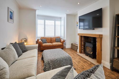 a living room with a couch and a fireplace at Host & Stay - Holme Rigg in Whitby