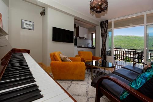 a living room with a piano and a couch at INES APARTMENTS in Ohrid
