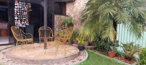 two chairs sitting on a patio in front of a building at Pousada Colina do Sol in Ametista do Sul