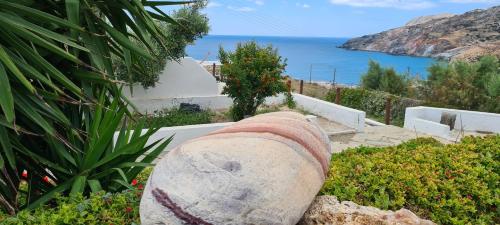 a stone wall in a garden with a view of the ocean at Avgerinou Studios in Paliochori