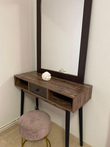 a wooden dressing table with a mirror and a stool at Anastasia's House Νιγρίτα near Serres in Nigríta