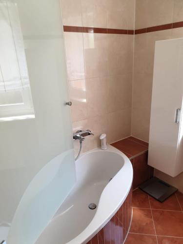a bathroom with a white tub and a sink at Ferienwohnung Nella in Amberg