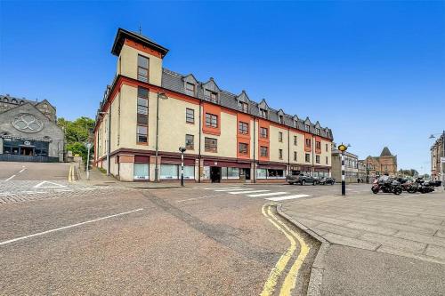 an empty street with a large building in a city at Waverley Court in Fort William