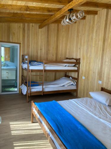 a bedroom with two bunk beds and a window at Bujtina Arturi in Valbonë